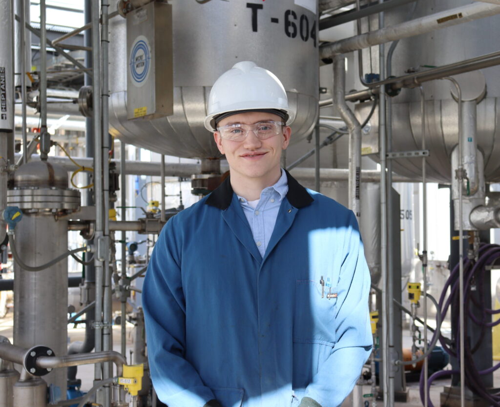 young man standing in front of Wiley Companies plant young man standing in front of Wiley Companies plant